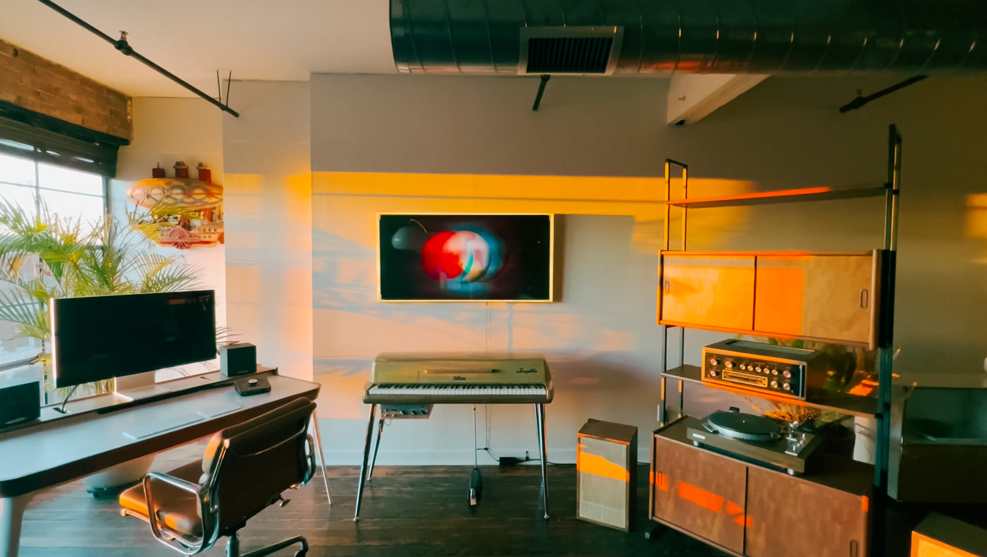 The Rarefy Audio studio — vintage keys, turntable, and monitors in a warm loft